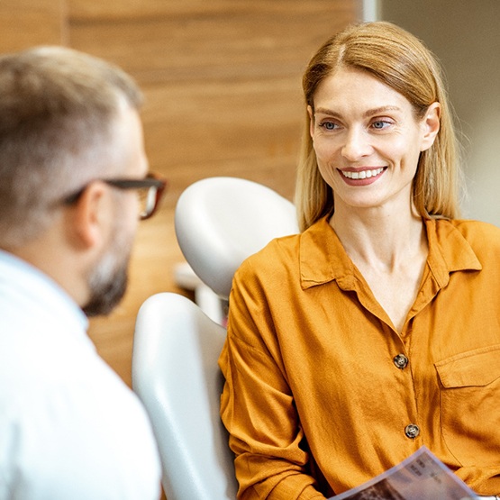 Female patient talking to her dentist