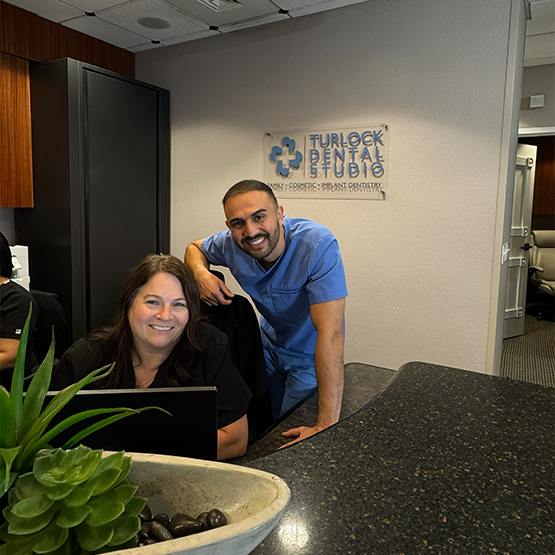 Dentist and team member at front desk