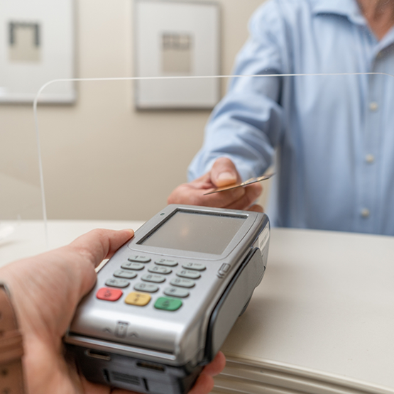 Holding out credit card reader for patient