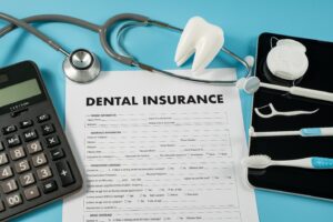 dental insurance paperwork and dental instruments